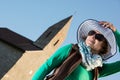 Young brunette with stylish hat and old romanesque church Royalty Free Stock Photo