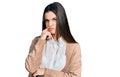 Young brunette teenager wearing casual white shirt and jacket serious face thinking about question with hand on chin, thoughtful Royalty Free Stock Photo