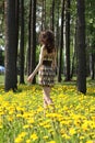 Young brunette walking along the meadow