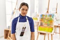 Young brunette woman at art studio looking sleepy and tired, exhausted for fatigue and hangover, lazy eyes in the morning