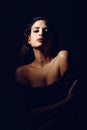 Young brunette woman in black lingerie in chiaroscuro lighting Royalty Free Stock Photo