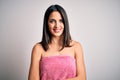 Young brunette woman with blue eyes wearing shower towel after bath over white background happy face smiling with crossed arms Royalty Free Stock Photo