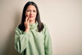 Young brunette woman with blue eyes wearing turtleneck sweater over white background touching mouth with hand with painful Royalty Free Stock Photo