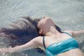 Young brunette woman in blue swimsuit. girl went into the water Royalty Free Stock Photo