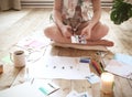 Young brunette woman creating her Feng Shui wish map using scissors Royalty Free Stock Photo