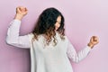 Young brunette woman with curly hair wearing casual clothes dancing happy and cheerful, smiling moving casual and confident Royalty Free Stock Photo