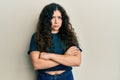 Young brunette woman with curly hair wearing casual clothes skeptic and nervous, disapproving expression on face with crossed arms Royalty Free Stock Photo