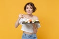 Young brunette woman girl in casual clothes hold in hand makizushi sushi roll served on black plate traditional japanese Royalty Free Stock Photo