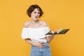 Young brunette woman girl in casual clothes hold in hand makizushi sushi roll served on black plate traditional japanese Royalty Free Stock Photo