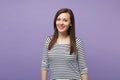 Young brunette woman girl in casual striped clothes posing isolated on violet purple wall background studio portrait Royalty Free Stock Photo