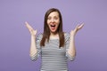 Young brunette woman girl in casual striped clothes posing isolated on violet purple background studio portrait. People Royalty Free Stock Photo