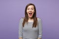 Young brunette woman girl in casual striped clothes posing isolated on violet purple wall background studio portrait Royalty Free Stock Photo