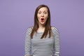 Young brunette woman girl in casual striped clothes posing isolated on violet purple wall background studio portrait Royalty Free Stock Photo