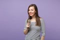 Young brunette woman girl in casual striped clothes posing isolated on violet purple background studio portrait. People Royalty Free Stock Photo