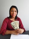 young brunette woman grabbing and showing American dollar money Royalty Free Stock Photo