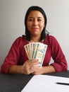 young brunette woman grabbing and showing cuban money