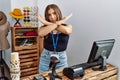 Young brunette woman holding banner with open text at retail shop rejection expression crossing arms doing negative sign, angry Royalty Free Stock Photo