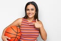 Young brunette woman holding basketball ball pointing finger to one self smiling happy and proud Royalty Free Stock Photo