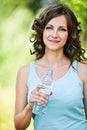 Young brunette woman holding bottle