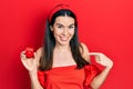 Young brunette woman holding engagement ring for proposal pointing finger to one self smiling happy and proud Royalty Free Stock Photo