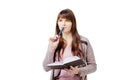 Young brunette woman holding a notebook and pen on white isolated background Royalty Free Stock Photo