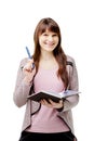 Young brunette woman holding a notebook and pen on white isolated background Royalty Free Stock Photo