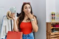 Young brunette woman holding shopping bags and dollars covering mouth with hand, shocked and afraid for mistake Royalty Free Stock Photo