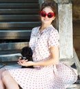 Young brunette woman hugging her lap dog puppy