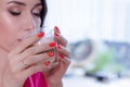 young brunette woman in kitchen wearing pink dressing gown with a cup of hot beverage coffee. tender woman portrait Royalty Free Stock Photo