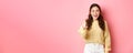 Young brunette woman laughing, smiling amazed and pointing at camera, choosing you, standing against pink background Royalty Free Stock Photo