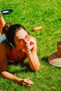 happy young brunette woman listening to the music outdoor on a summer day