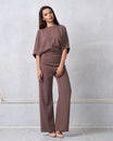 Young woman in fashionable mauve jumpsuit