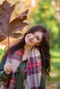 A young brunette woman with a maple leaf.