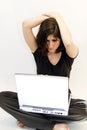 Young brunette woman perplexed by computer