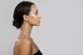 Young brunette woman portrait. Bare shoulders. Side view Royalty Free Stock Photo