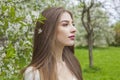 Young brunette woman portrait. Beautiful female model with long hair and make-up in spring garden outdoor Royalty Free Stock Photo