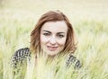 Young brunette woman posing in the wheat field, beauty and nature