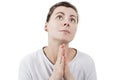 Young brunette woman praying to God and palms together in front of face isolated on white background Royalty Free Stock Photo