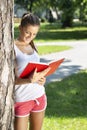 young brunette woman reading to notepad Royalty Free Stock Photo