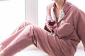 Young brunette woman relaxing with red wine at home. Quarantine, isolation, coronavirus pandemic world. Stay at home Royalty Free Stock Photo