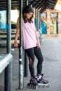 Young brunette woman on rollerskate smiling