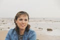 young brunette woman by the sea, copy space