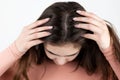 Young brunette woman showing her scalp, hair roots, color, grey hair, hair loss or dry scalp problem