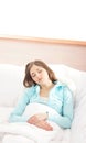 A young brunette woman sleeping on a white bed Royalty Free Stock Photo