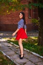Young woman spinning in the park. girl in red skirt dance outdoor Royalty Free Stock Photo
