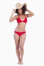 Young brunette woman standing upright in a swimsuit Royalty Free Stock Photo