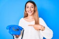 Young brunette woman using vintage telephone smiling happy pointing with hand and finger Royalty Free Stock Photo