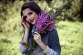 Young brunette woman walks in a summer forest park wearing stylish casual clothes Royalty Free Stock Photo