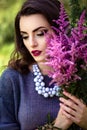 Young brunette woman walks in a summer forest park wearing stylish casual clothes Royalty Free Stock Photo