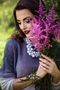 Young brunette woman walks in a summer forest park wearing stylish casual clothes Royalty Free Stock Photo